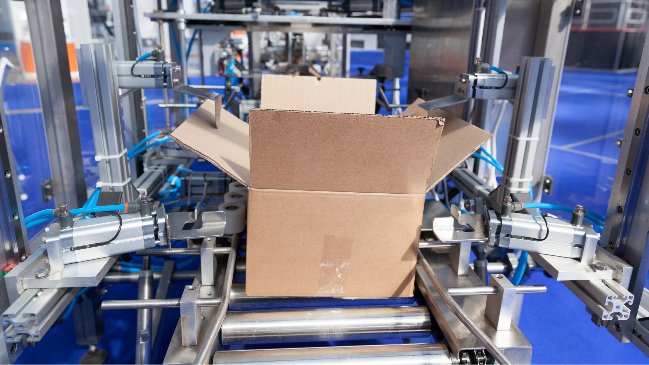 Box loaded onto conveyer waiting to be packaged by a robot